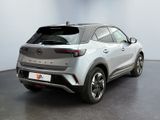 the rear end of a silver suv parked in a showroom