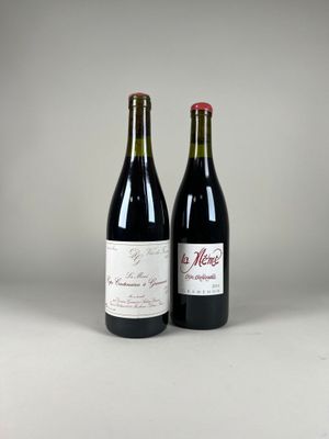 two bottles of wine sitting next to each other on a table