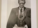 a black and white photo of a man in a suit and tie