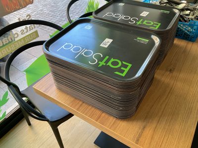 two trays of food sitting on top of a table