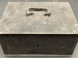 a metal box with a lock on it on a table