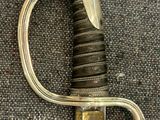 a silver and gold sword with a black handle