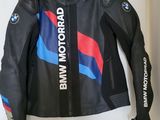 leather jacket with bmw logo on it hanging on a wall