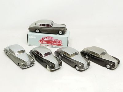 several toy cars are lined up in a row in front of a box