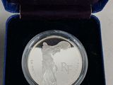 a close up of a silver coin in a velvet case