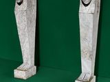 two statues of a man and a woman on a green surface