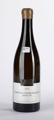 bottle of white wine sitting on a table with a white background