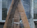 a picture of a wooden structure that is wrapped in plastic