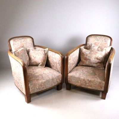 two chairs sitting next to each other on a white floor