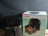 an image of a box of food sitting on a table next to an air fryer