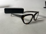 a pair of glasses sitting on a table next to a case
