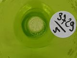 a close up of a green vase with a sticker on it