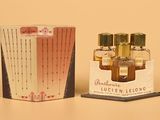 a small box of perfume sitting next to a small box of perfume