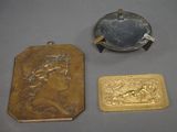 three gold and silver items including a cigarette case, a cigarette holder, and a lighter