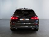 the rear end of a black audi suv parked in a showroom