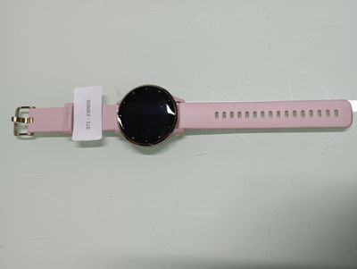the pink watch is sitting on a white surface next to a white tag