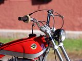 a red motorcycle parked on the side of the road
