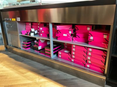 many pink boxes on the shelves in the store