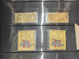 five different stamps in a black case on display