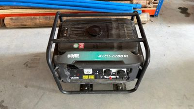 an electric generator sitting on top of a pile of wood
