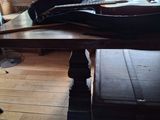 une table sur laquelle est posé un étui à guitare, devant une fenêtre