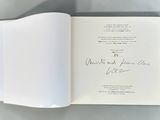 an open book with a handwritten signature on it