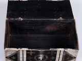 an old wooden box with a metal handle on a white surface