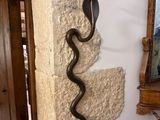 a candle that is on a stone wall next to a mirror