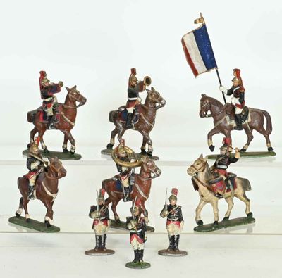 several figurines of soldiers riding horses and holding flags