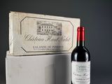 a bottle of wine sitting next to a box of wine