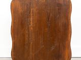 an old wooden cutting board sitting on top of a cement floor