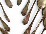 many spoons and spoon spoons arranged together on a white surface