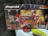 a box of playmobil with a picture of two people on it