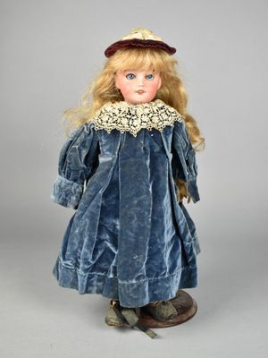a close up of a doll wearing a blue dress and hat