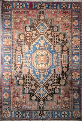 an antique persian rug with a blue and red design