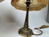 a lamp that is sitting on a table next to a pair of scissors