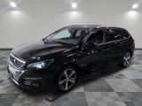 the black car is parked on a checkered floor in the garage