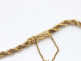 an image of a gold bracelet with a chain on it