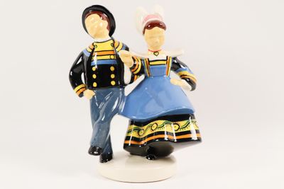 a figurine of a man and a woman standing next to each other