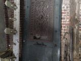 a door in a brick building that has a carved design on it