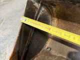 someone is measuring the height of the back end of a bulldozer