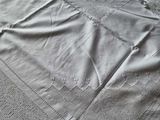 bedspread made of white linen with a crochet design