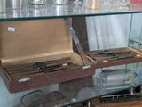 a glass display case with a bunch of knives in it