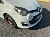 a small white car parked on the side of the road