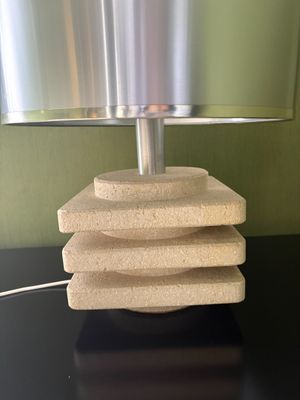 a table with a lamp and a stack of sponges on it