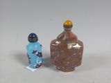 two small bottles sitting next to each other on a table
