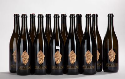 six bottles of six different types of wine lined up in a row