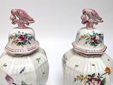 two vases with birds on them sitting next to each other