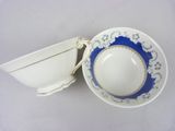 two cups and a saucer sitting on a table