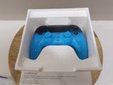 a blue controller in a white box on a table